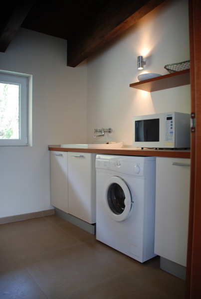 Utility room (accessed from living room) with washing machine and microwave