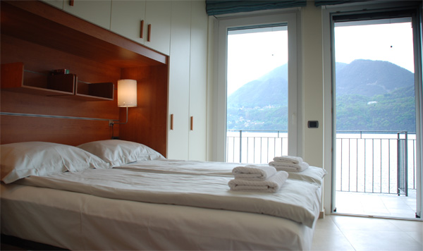 Bedroom 2, with twin beds that can be pushed together and made up with double mattress topper. Also with panoramic lake views!